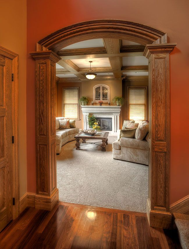 A living room with a fireplace , couch , table and chairs.