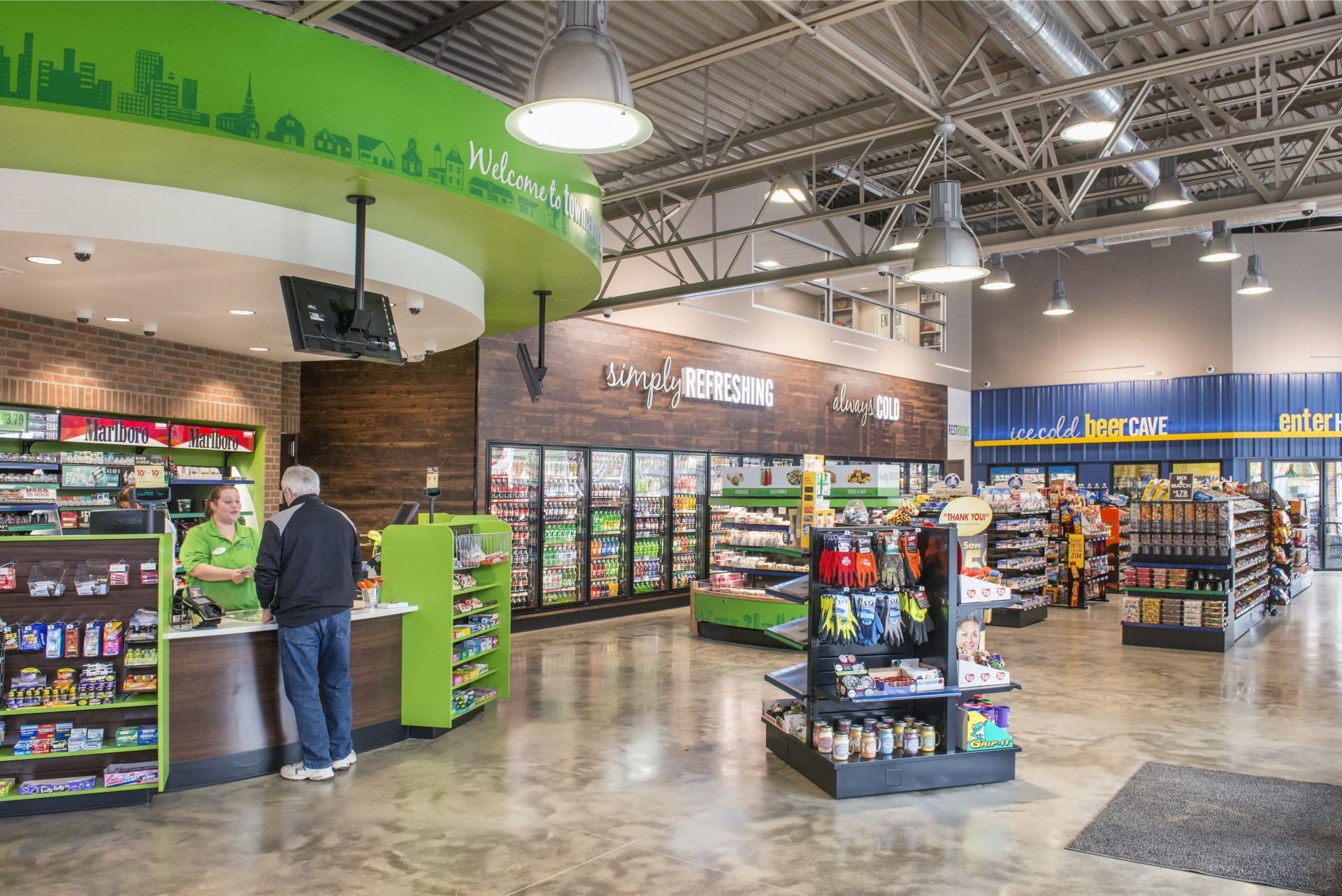 A man is standing at a counter in a convenient store.