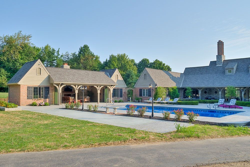 A large house with a swimming pool in front of it.