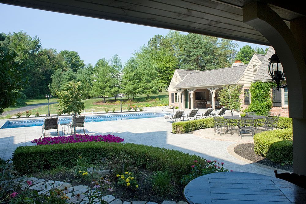 A large house with a swimming pool in view.