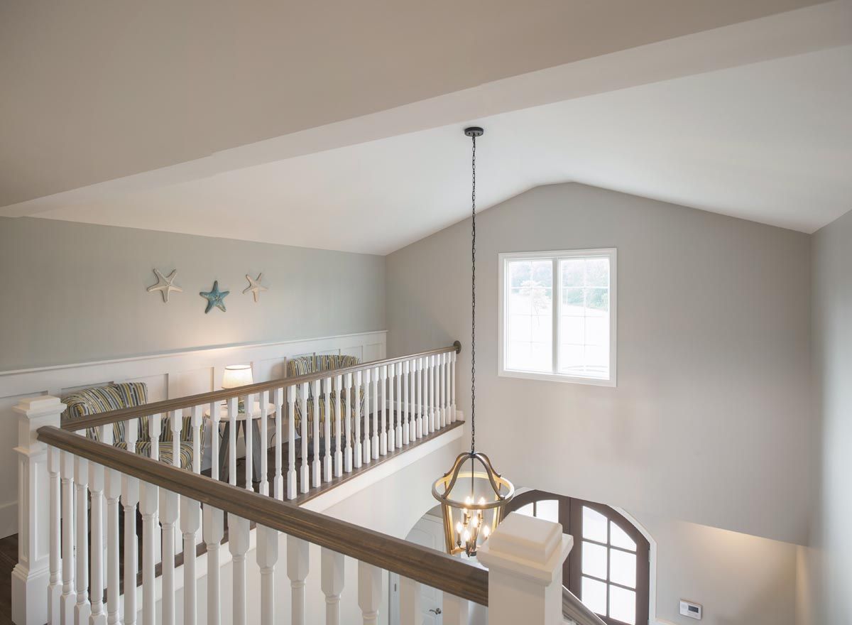 A view of a staircase from the second floor of a house.