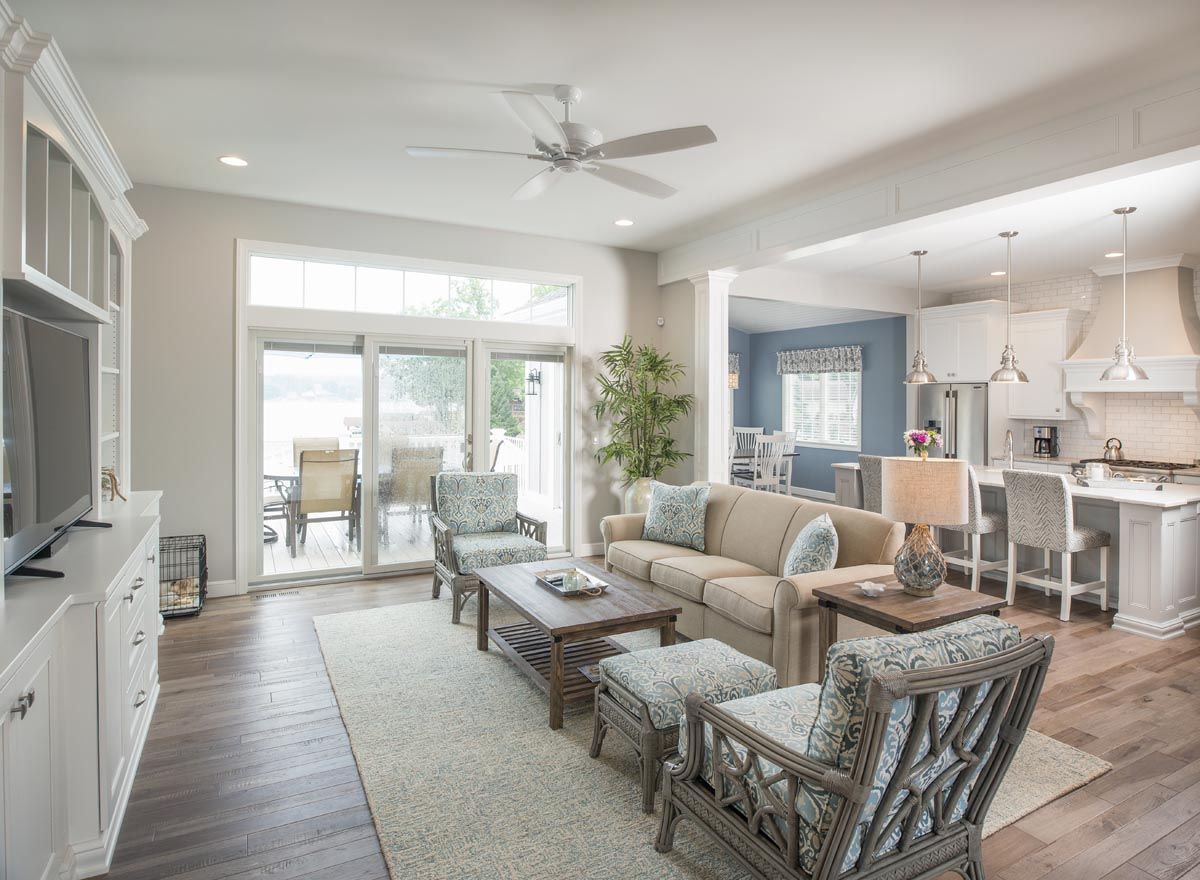 A living room filled with furniture and a ceiling fan.