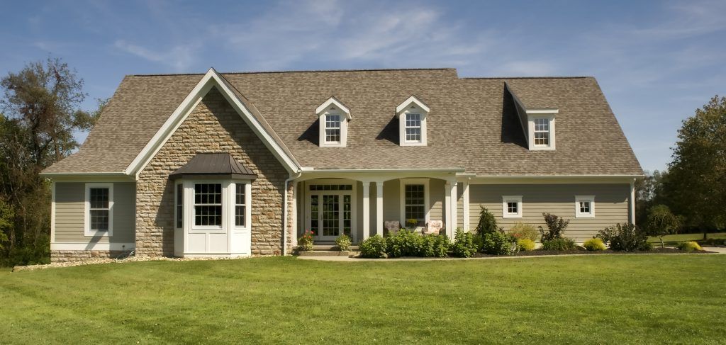 A large house with a large lawn in front of it.