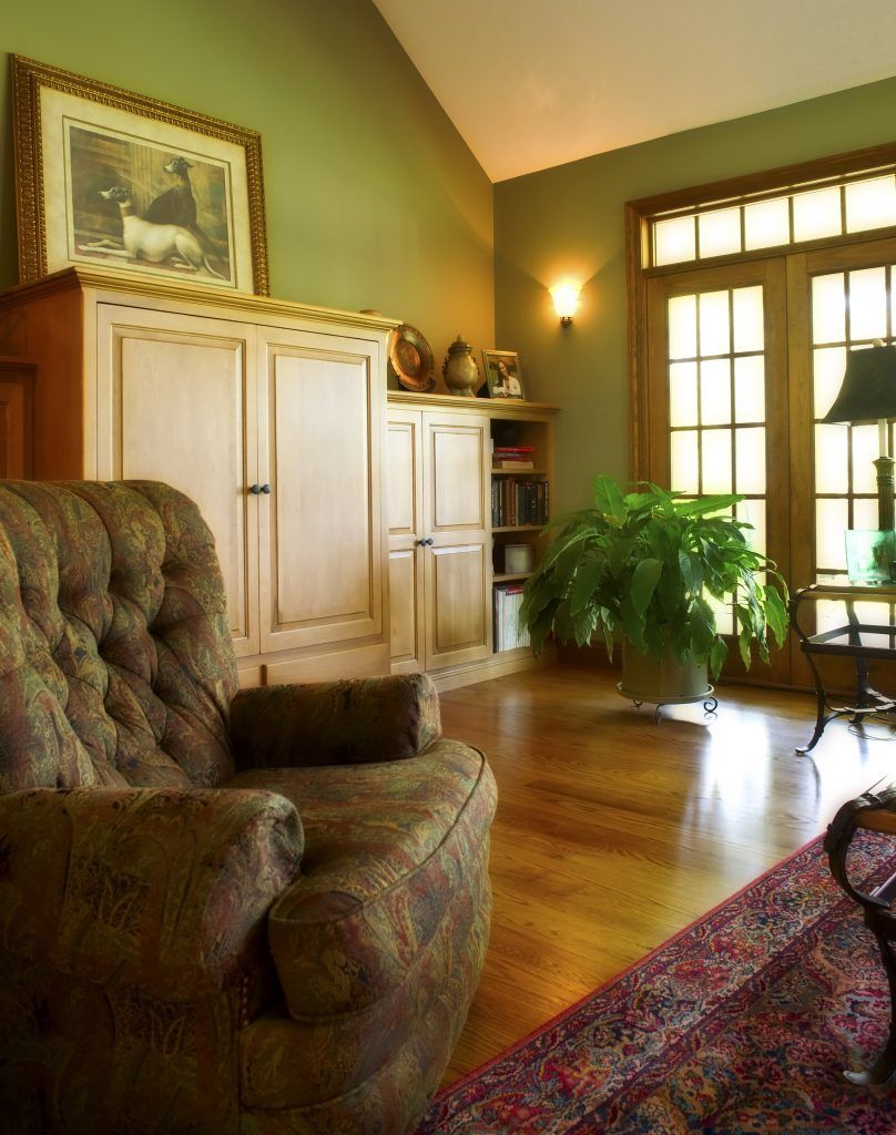 A living room with a chair and a lamp.