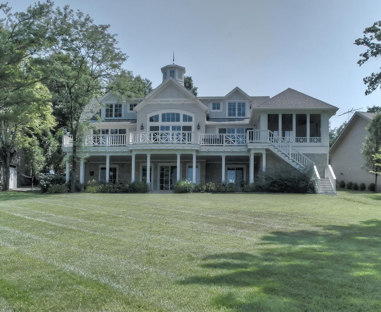 A large house with a large lawn in front of it.