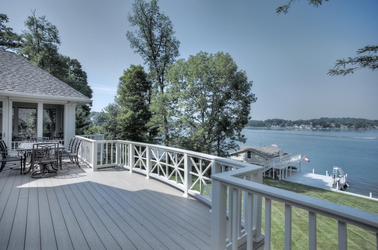A deck overlooking a body of water with a gazebo in the background.