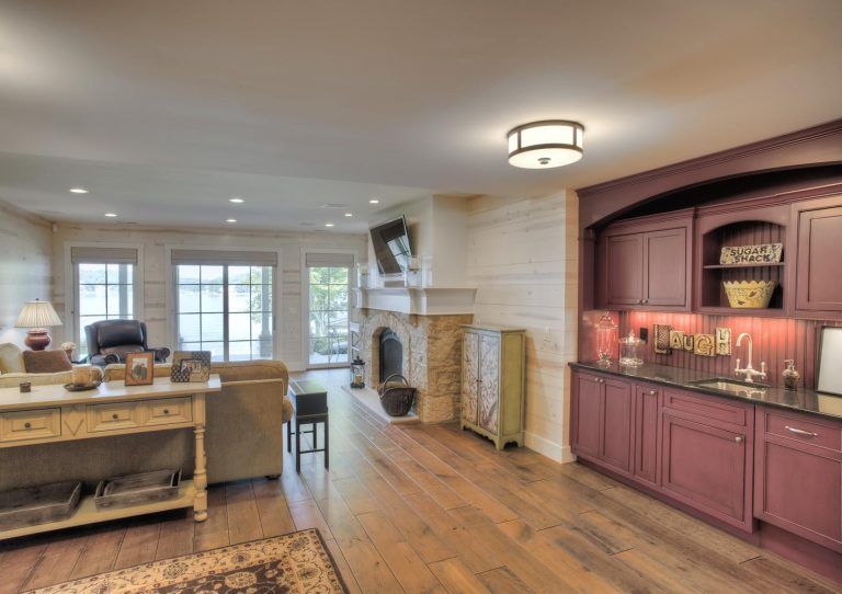 A living room with purple cabinets and a fireplace.