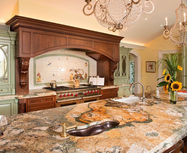 A kitchen with granite counter tops and a stove top oven.