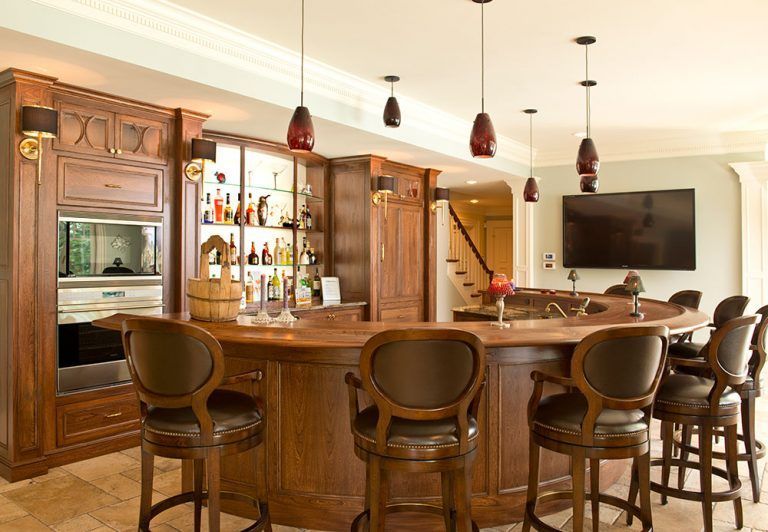 A bar with stools and a flat screen tv on the wall.
