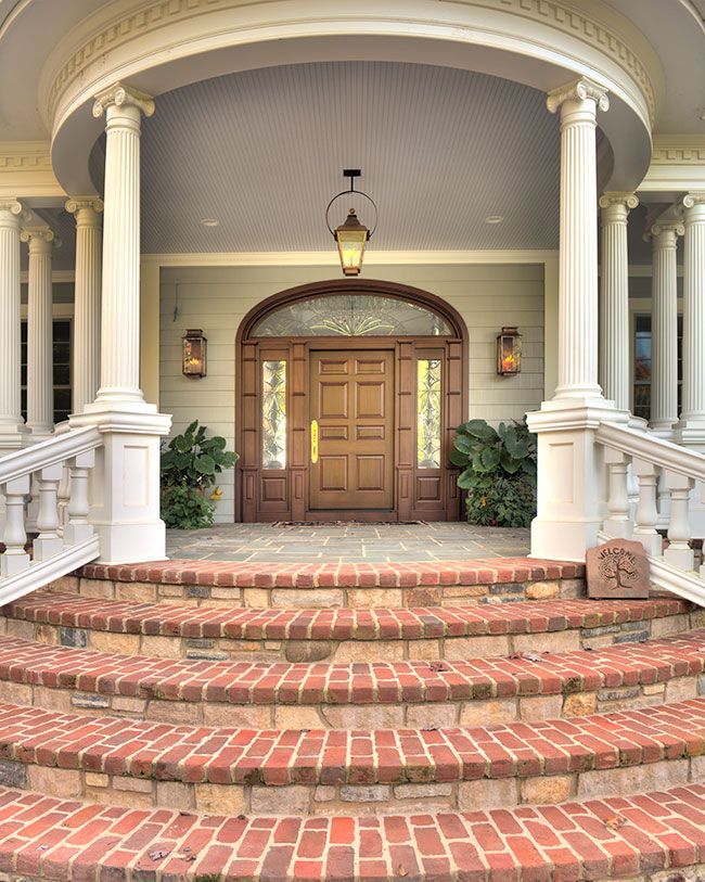 A large house with brick steps leading up to the front door.