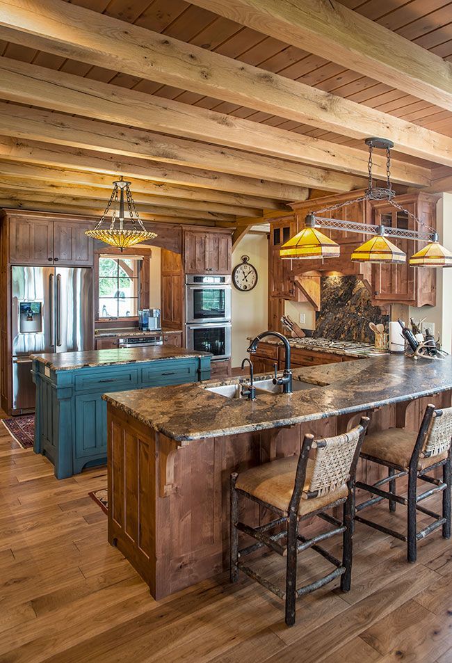 A kitchen with wooden cabinets , granite counter tops , and a large island.