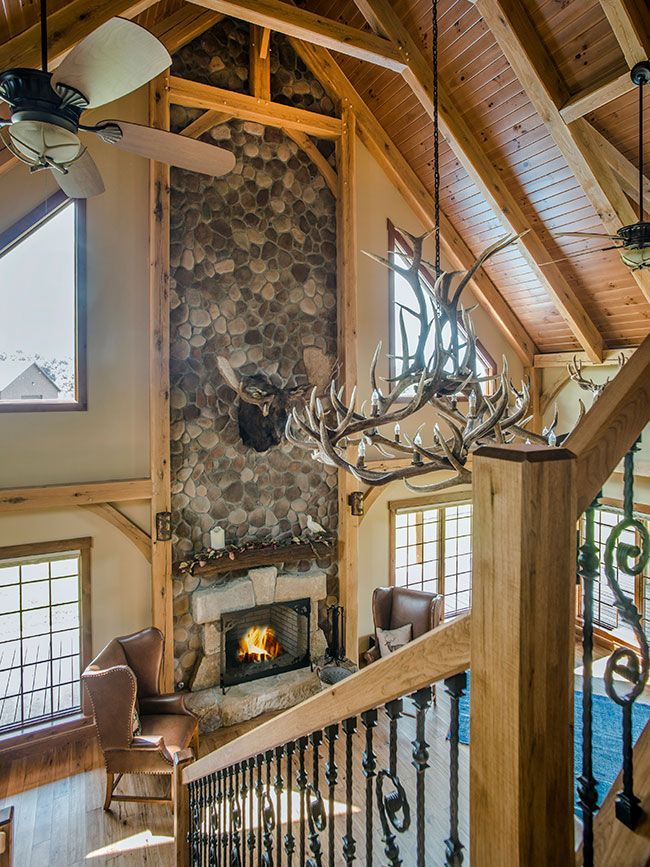 A living room with a fireplace and a ceiling fan.