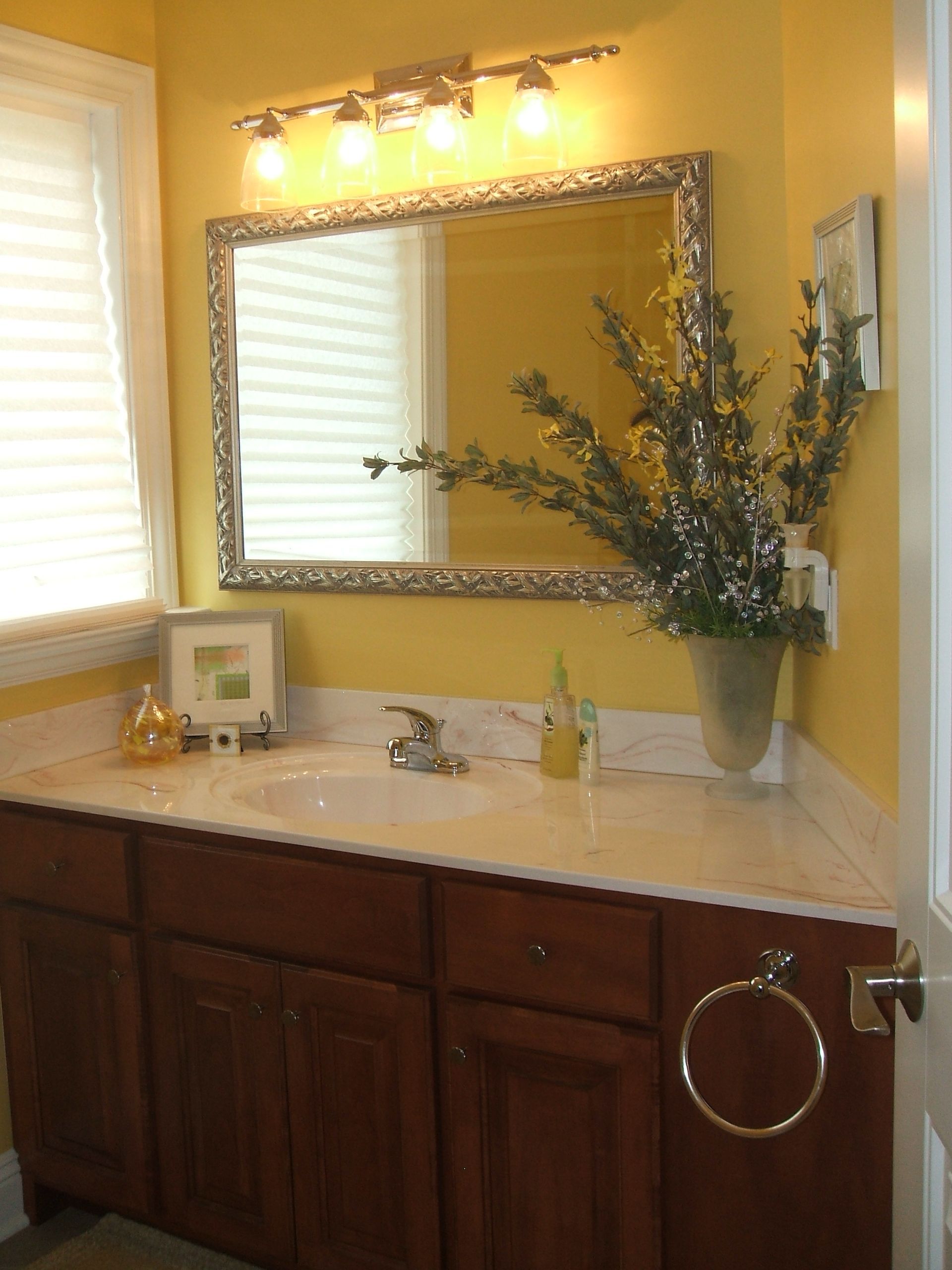 A bathroom with a sink and a large mirror