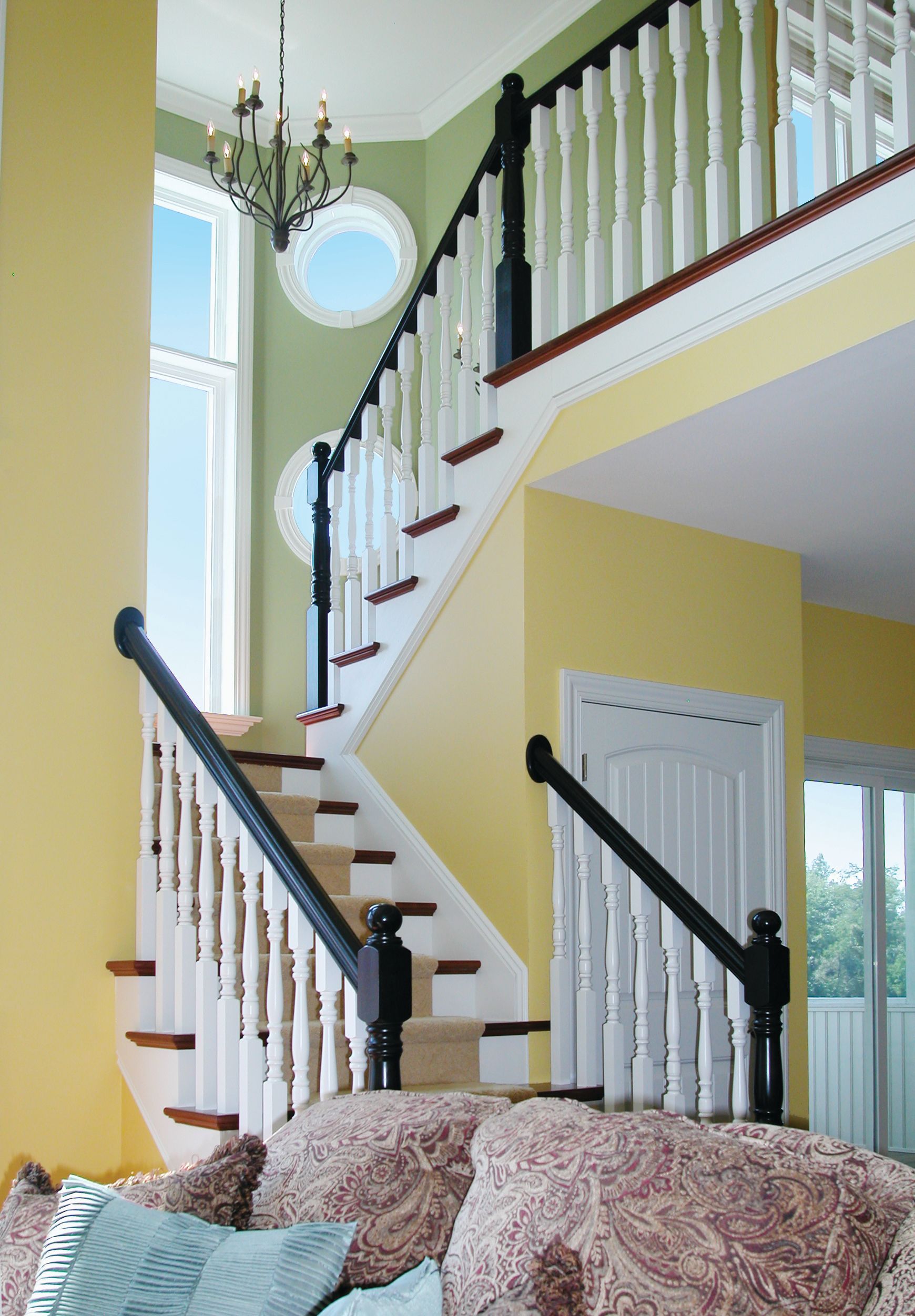 A living room with stairs leading up to the second floor