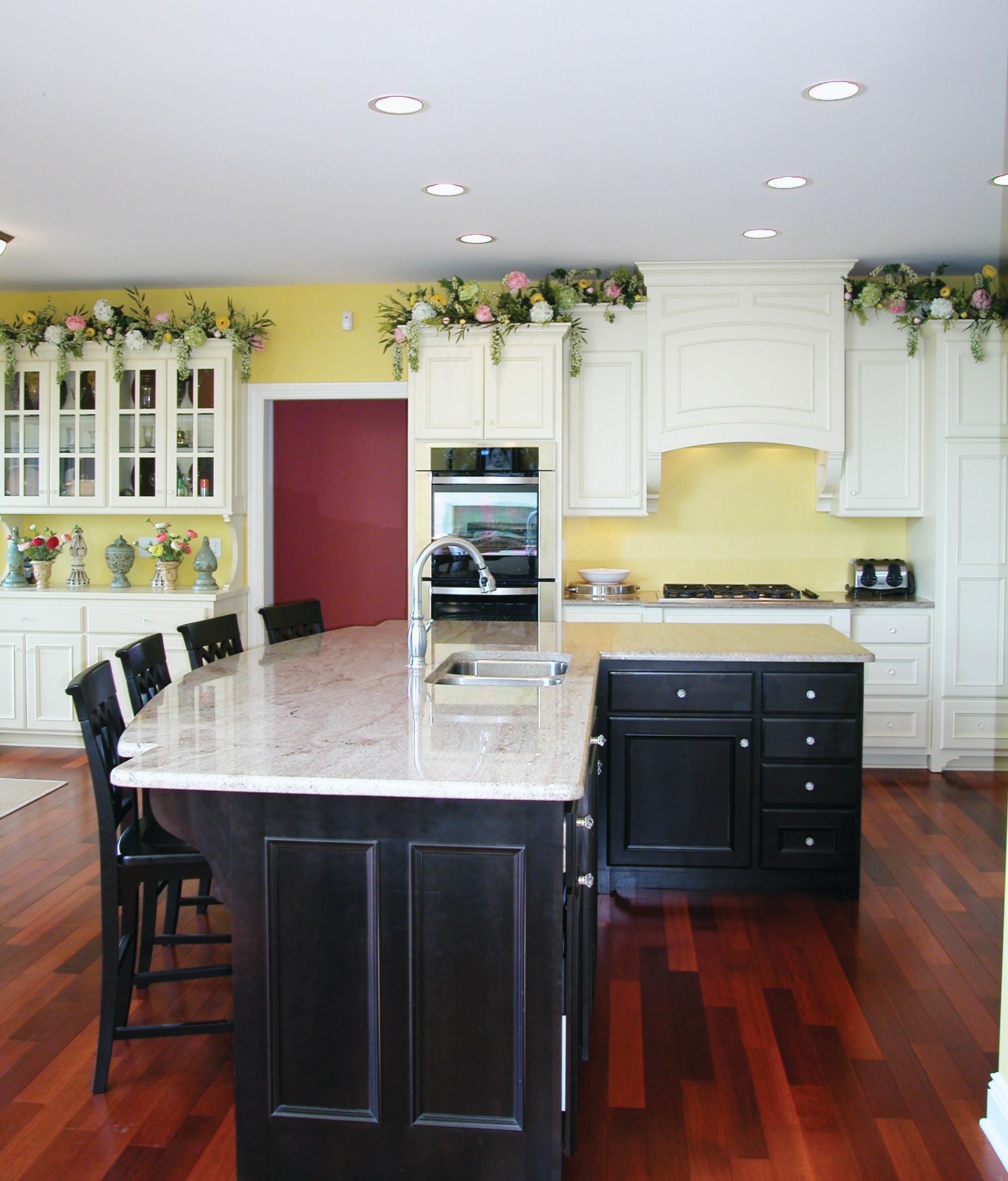 A kitchen with black cabinets and a large island