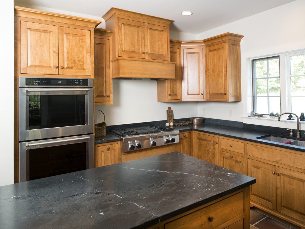 A kitchen with stainless steel appliances and wooden cabinets