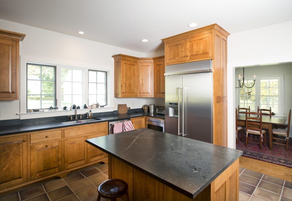 A kitchen with stainless steel appliances and wooden cabinets.