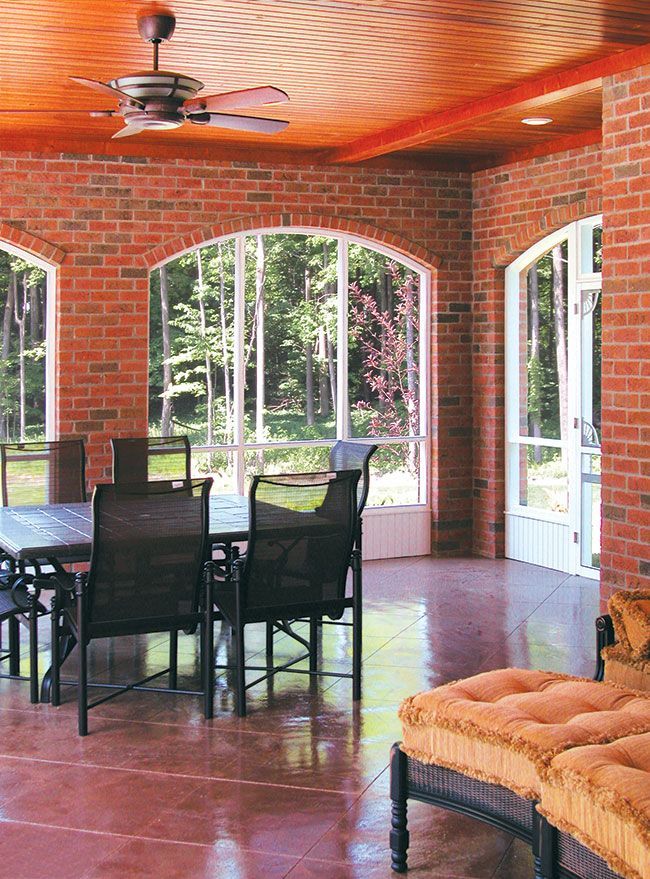 A room with a table and chairs and a ceiling fan.