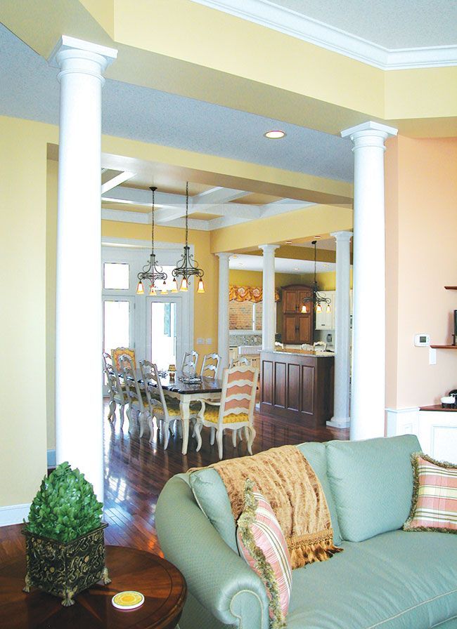 A living room with a couch and a table and chairs.