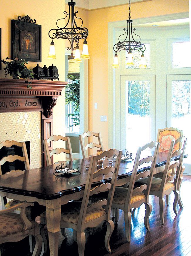 A dining room with a long table and chairs.