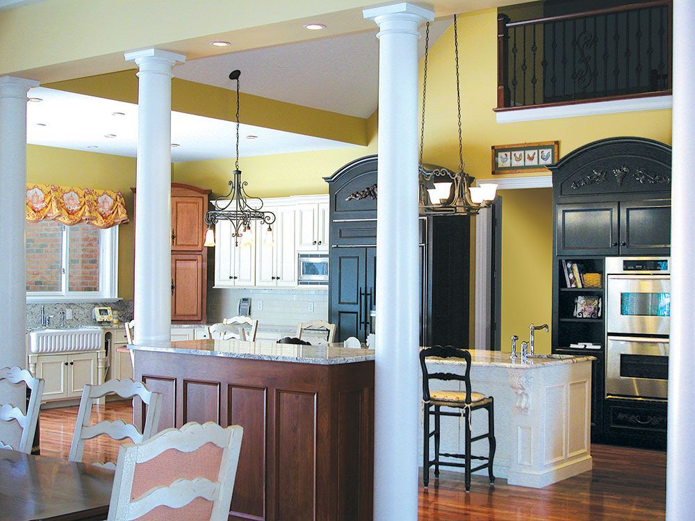 A kitchen with a large island and a dining table.
