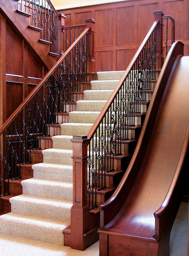 A wooden staircase with a slide attached to it.