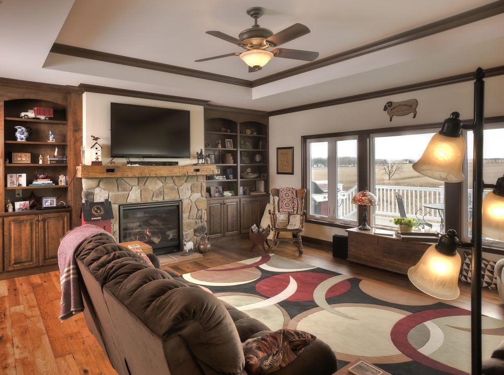 A living room with a couch a fireplace and a flat screen tv.