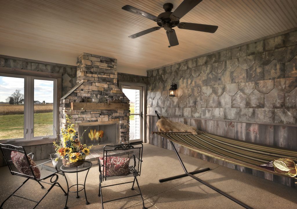 A living room with a hammock and a fireplace.