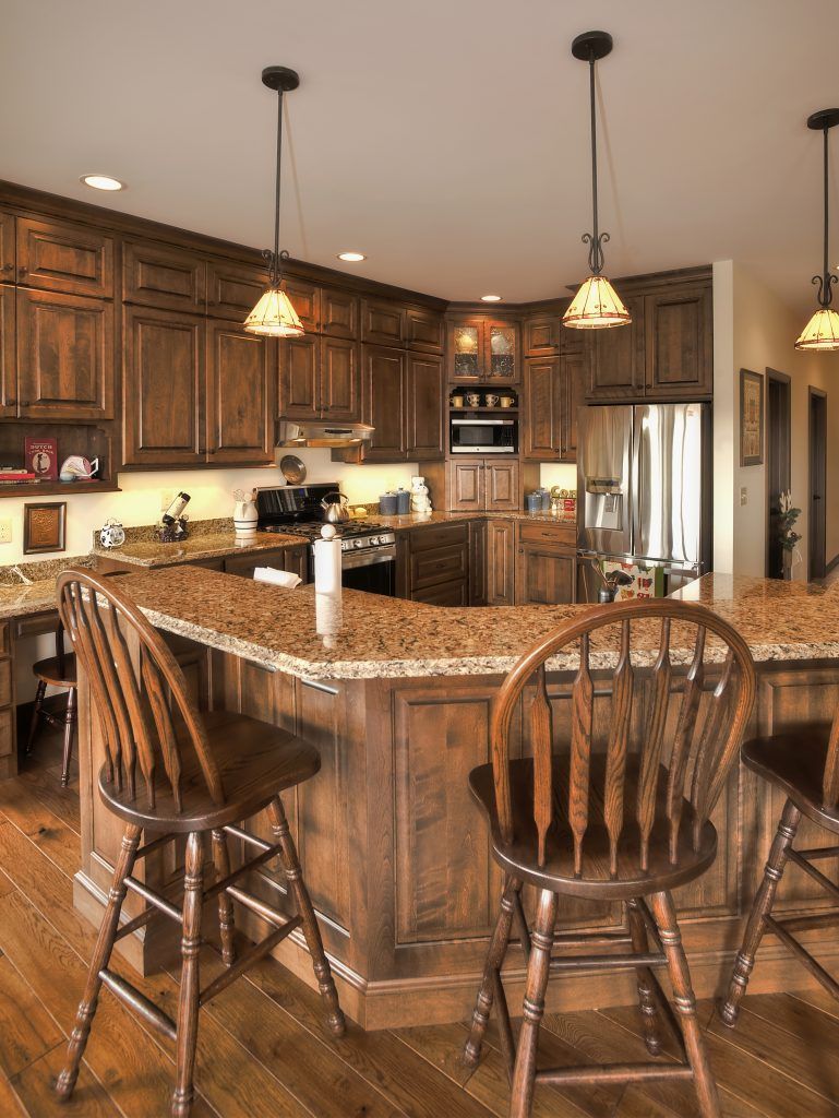 A kitchen with wooden cabinets and granite counter tops.