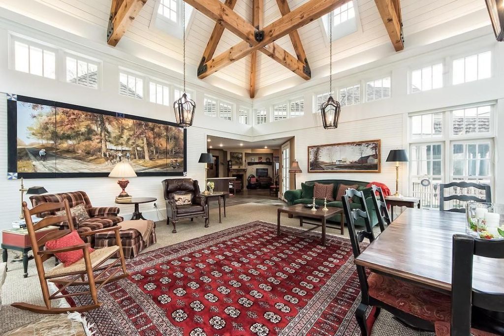 A living room filled with furniture and a rug.