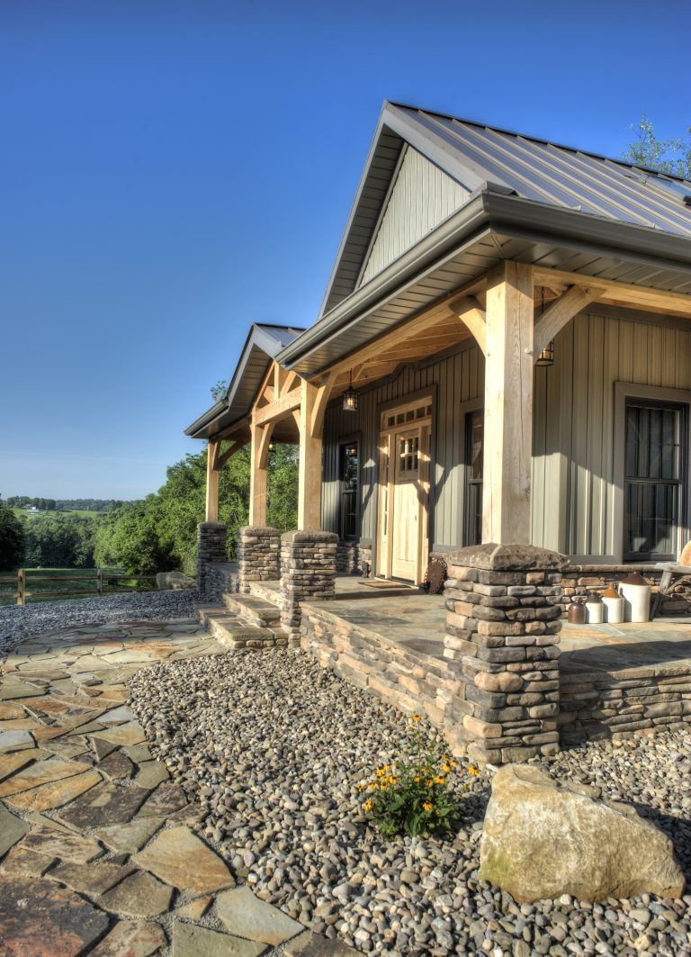 A house with a porch and a stone walkway.