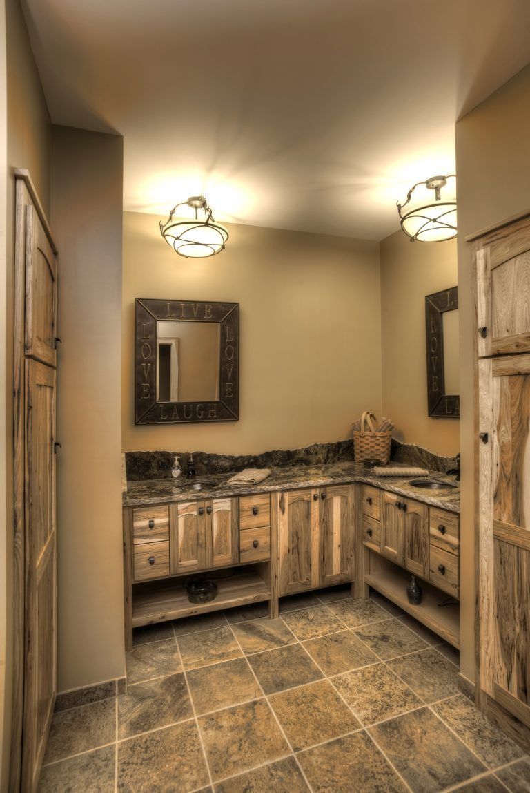 A bathroom with two sinks and a mirror on the wall.