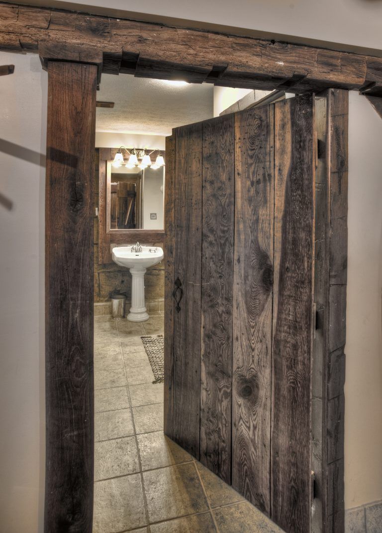 A bathroom with a sink and a wooden door.