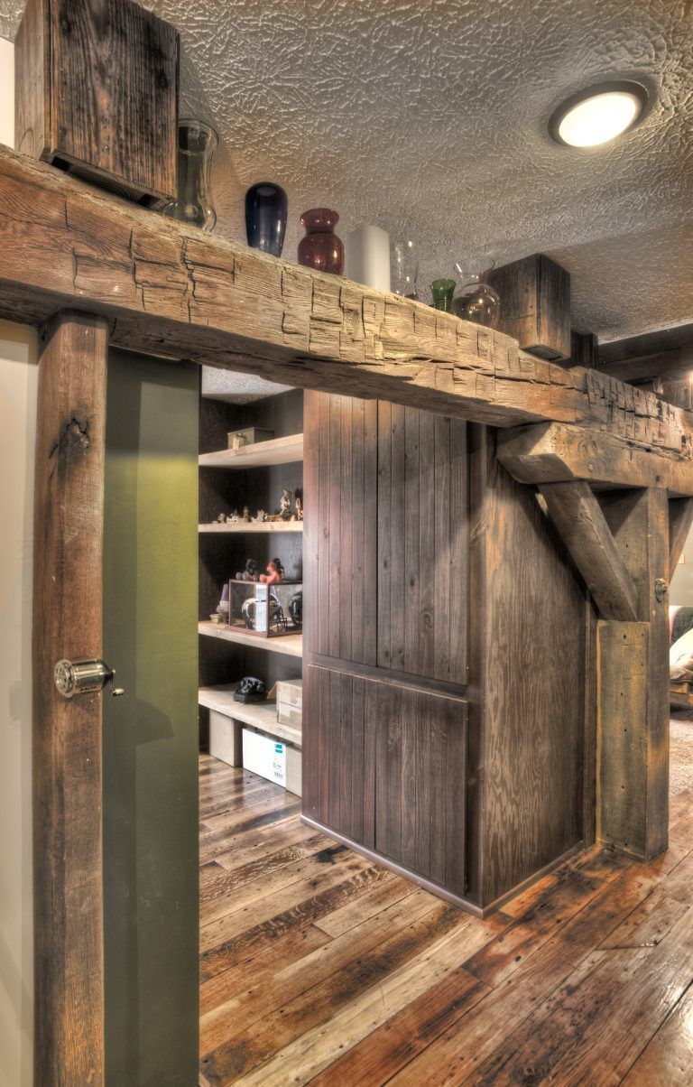 A wooden door is open to a room with shelves and a ceiling light.