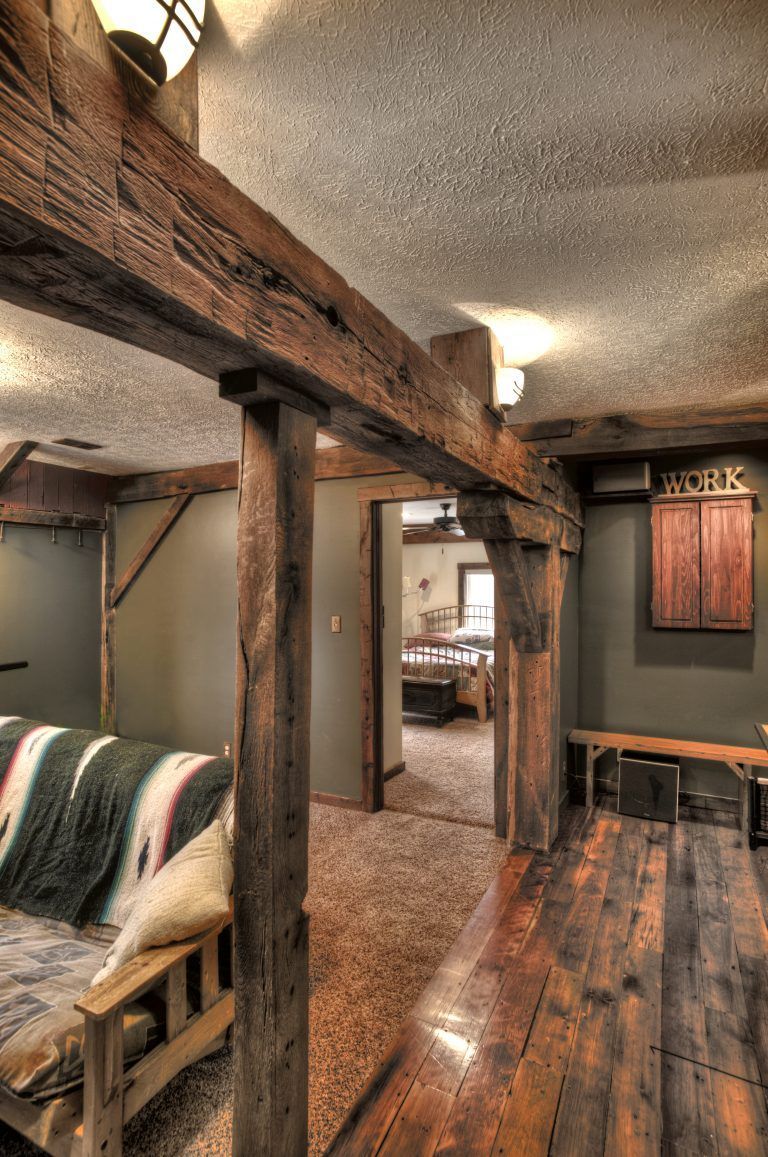 A living room with wooden beams and a couch.