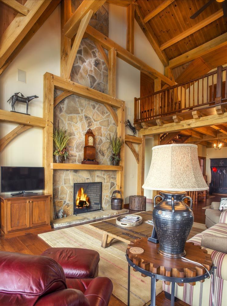 A living room with a fireplace and a lamp.