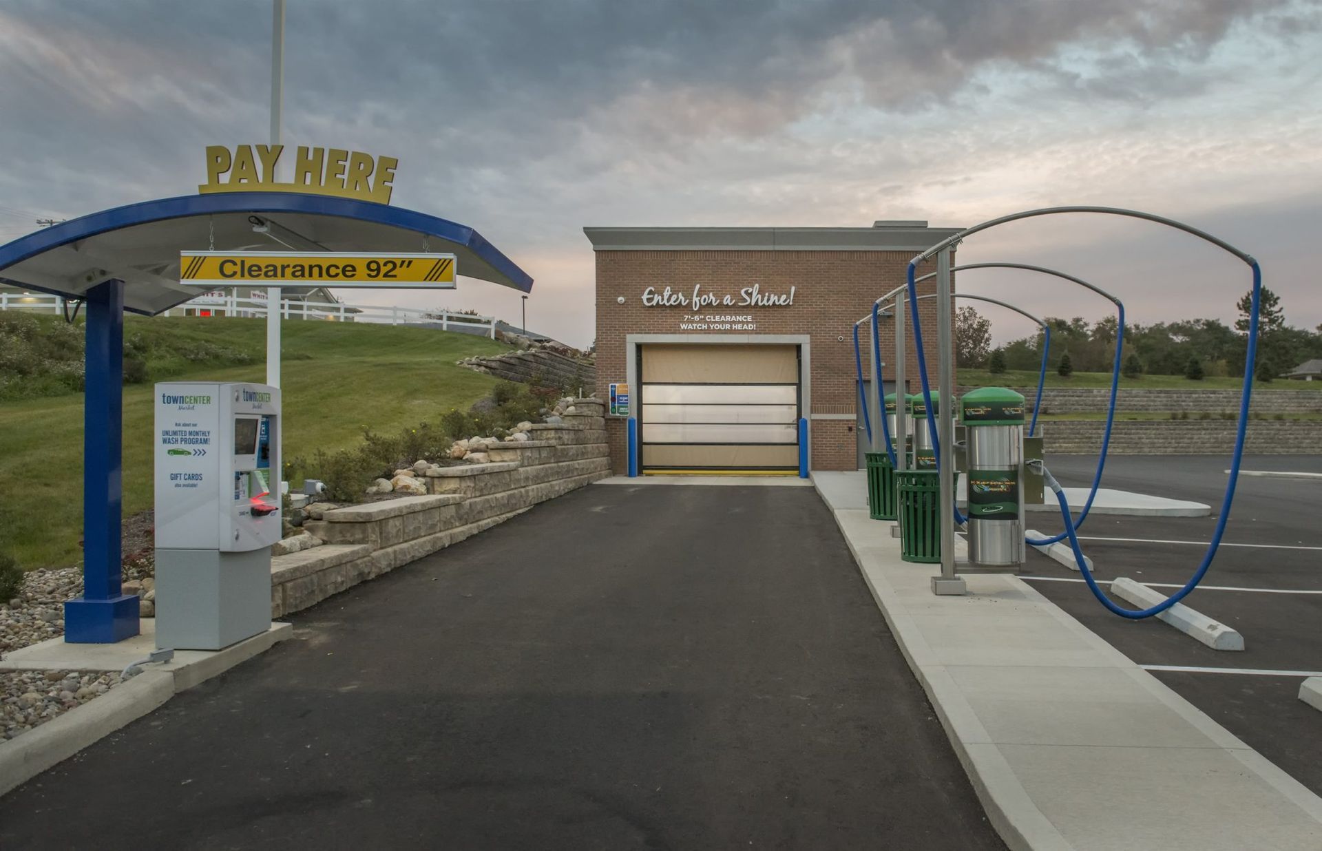 A car wash with a sign that says pay here.