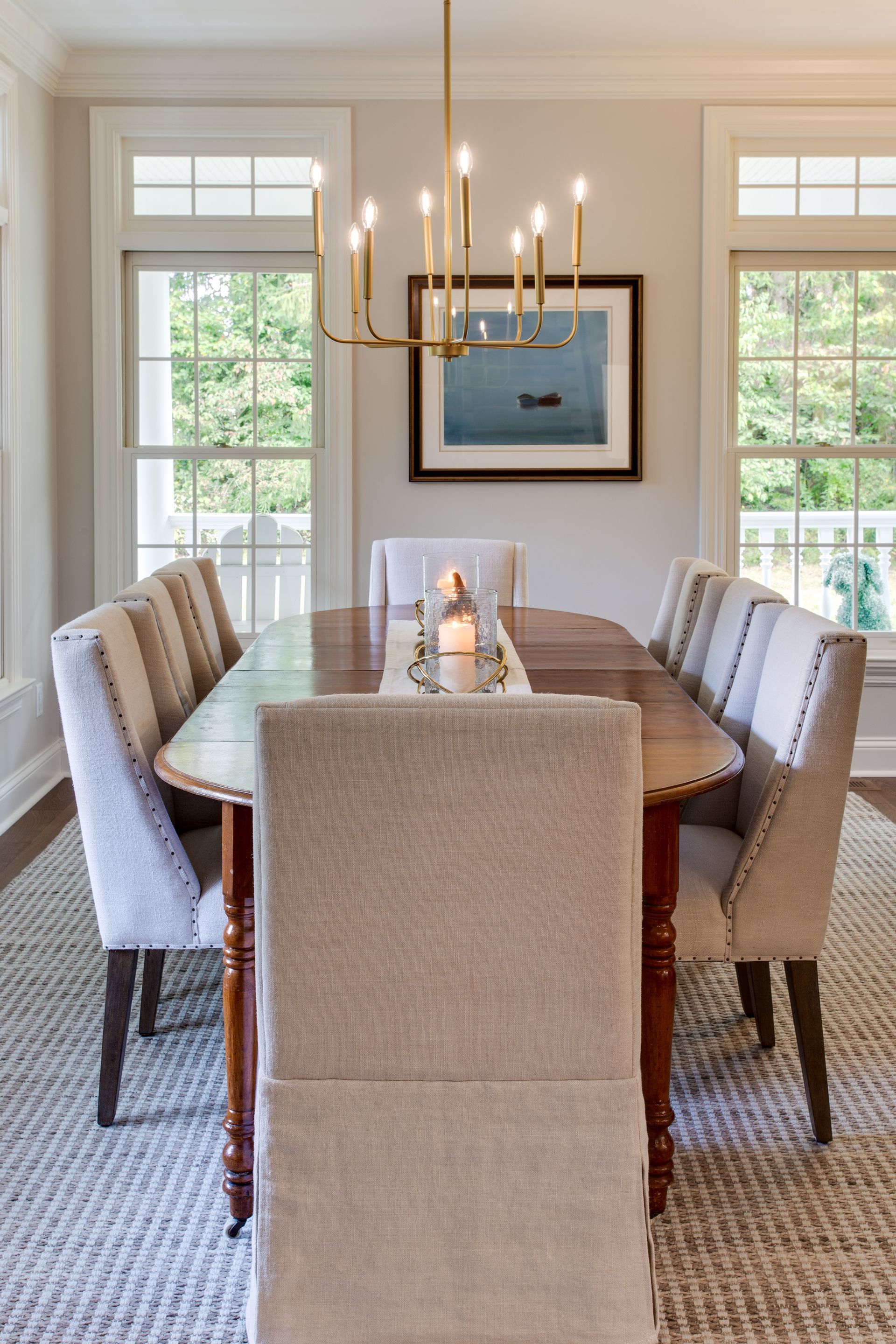 A dining room with a table and chairs and a chandelier.