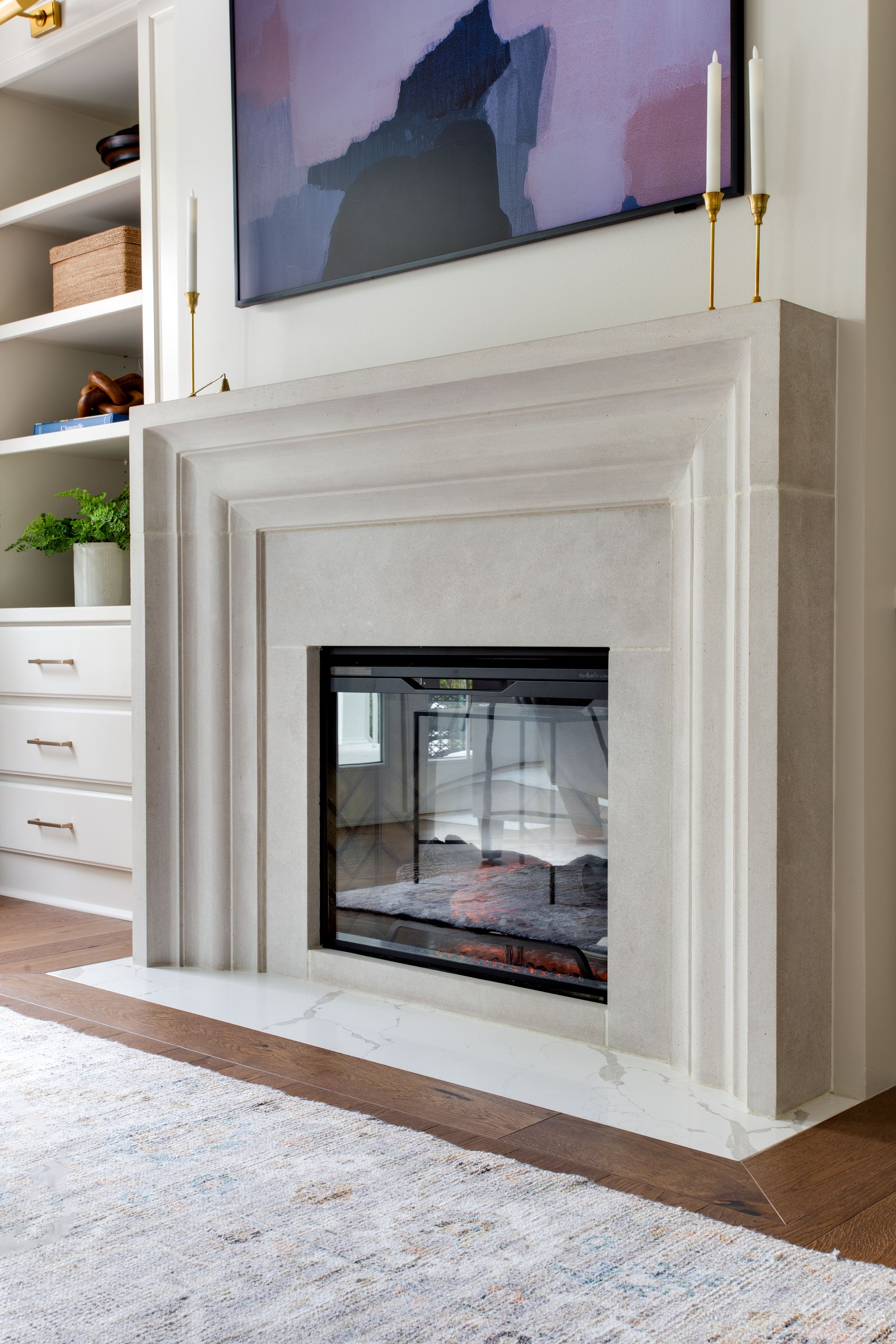 A fireplace in a living room with a flat screen tv above it.