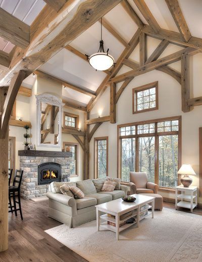 A living room with a fireplace and lots of windows