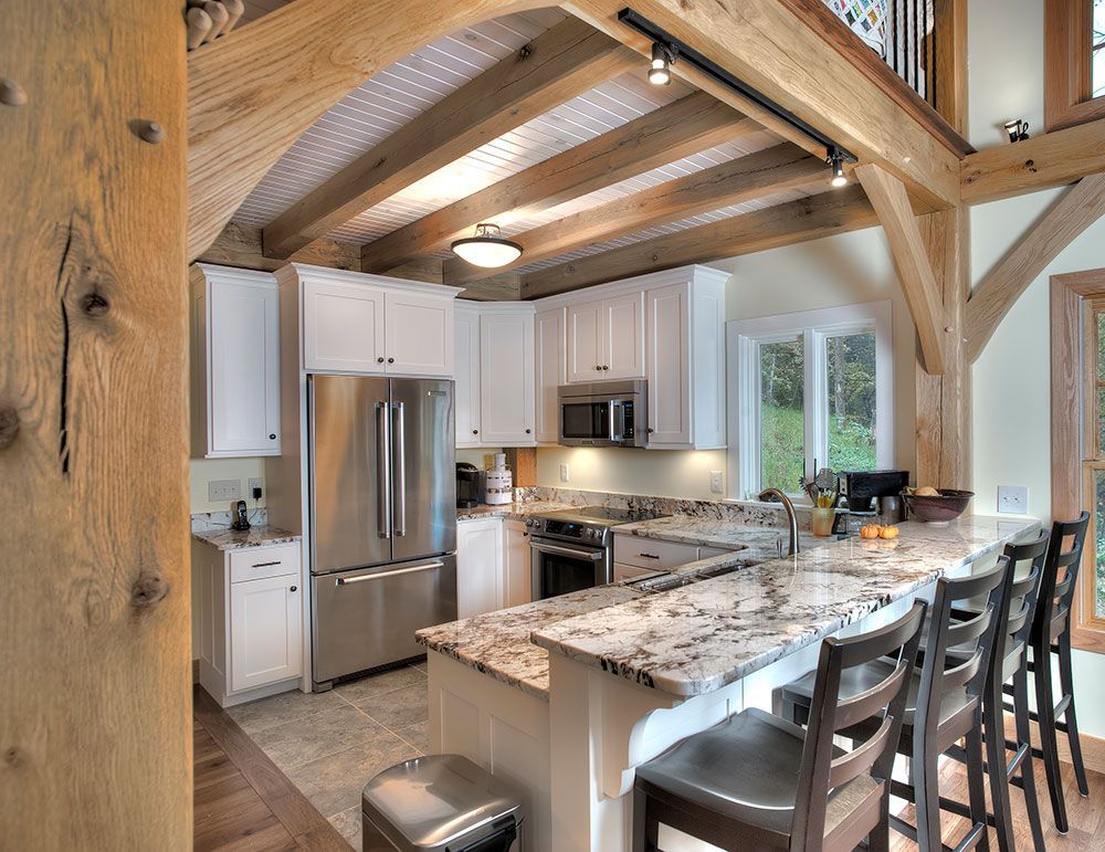 A kitchen with stainless steel appliances and granite counter tops.