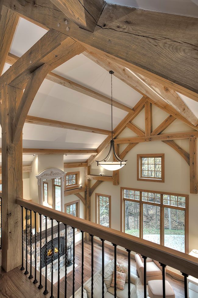 A living room with a fireplace and lots of windows.