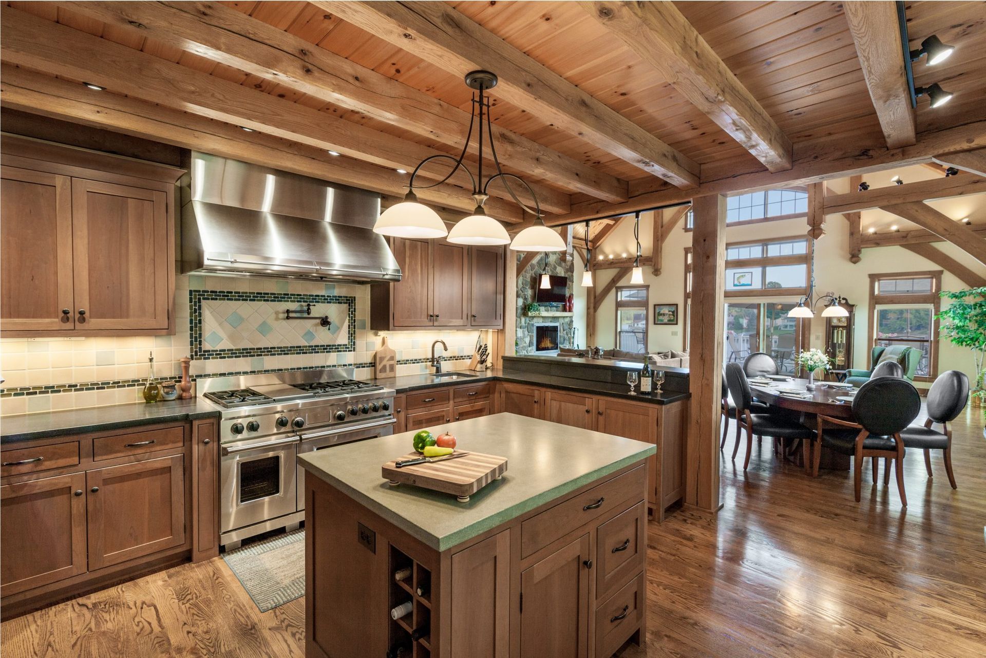 A kitchen with hardwood floors, stainless steel appliances, and wooden cabinets.