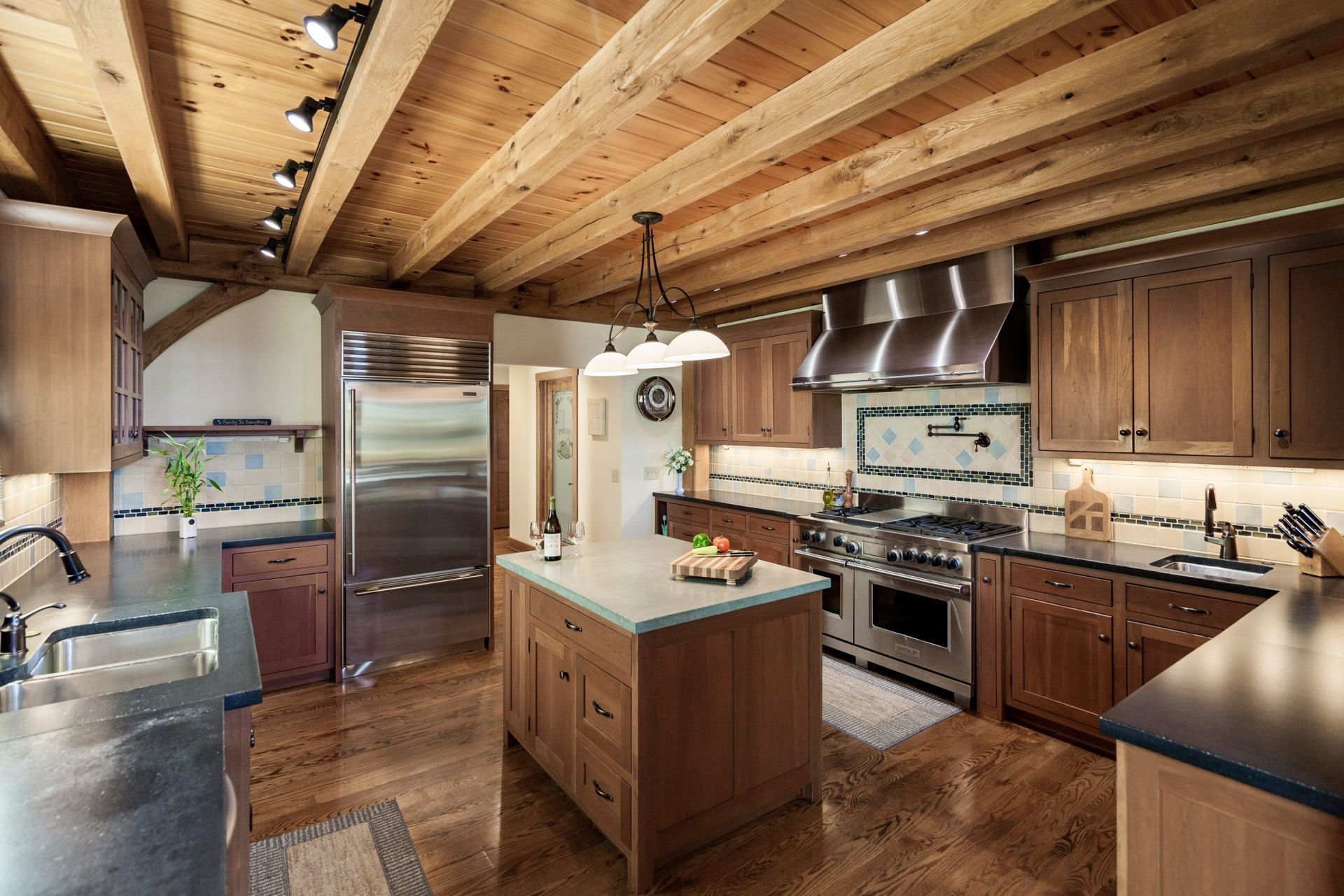 A kitchen with stainless steel appliances and wooden cabinets.