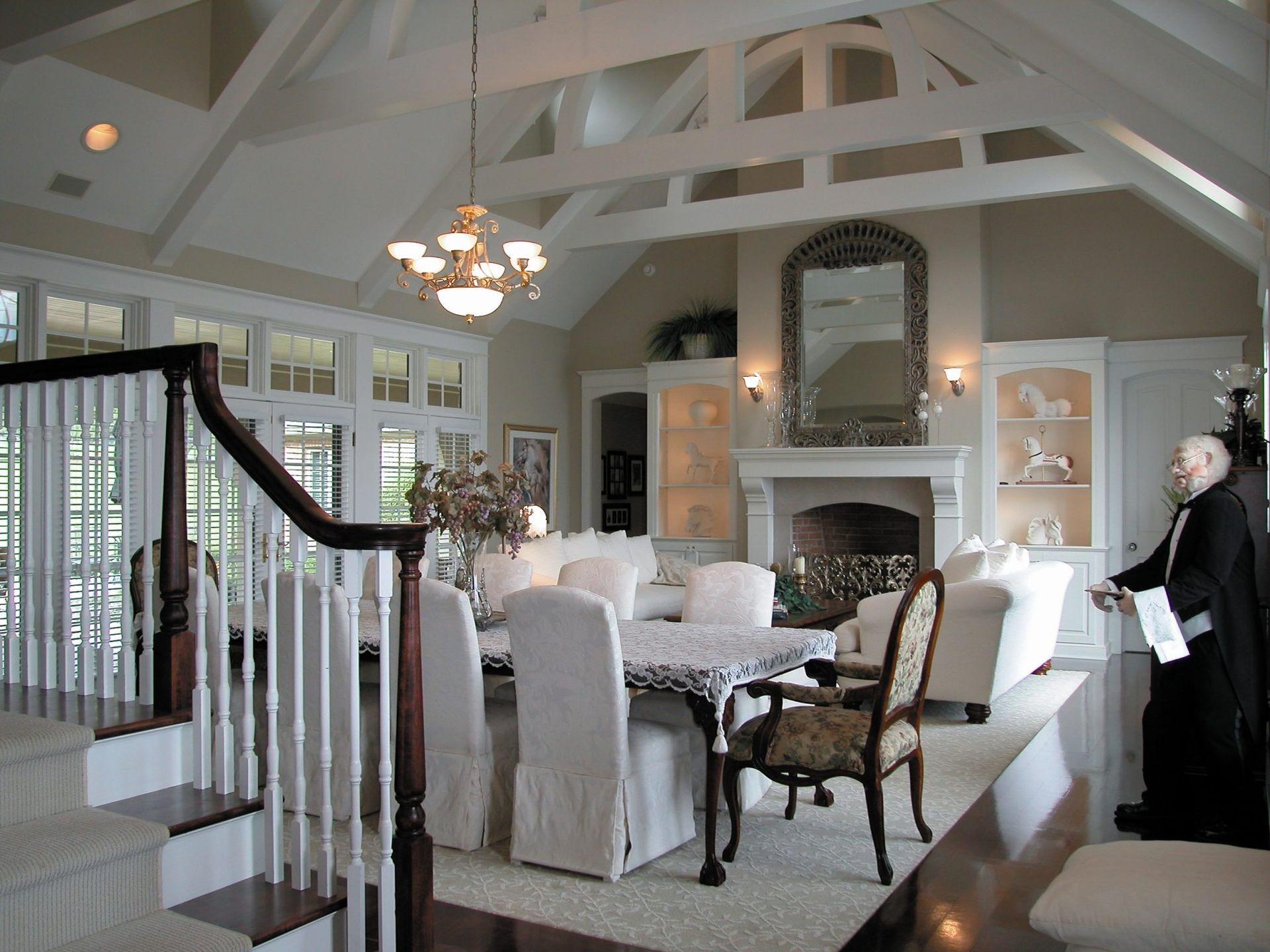 A large living room with a fireplace and stairs.