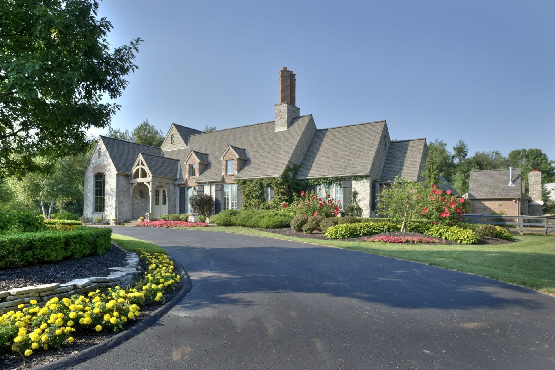 A large house with a lot of flowers in front of it.