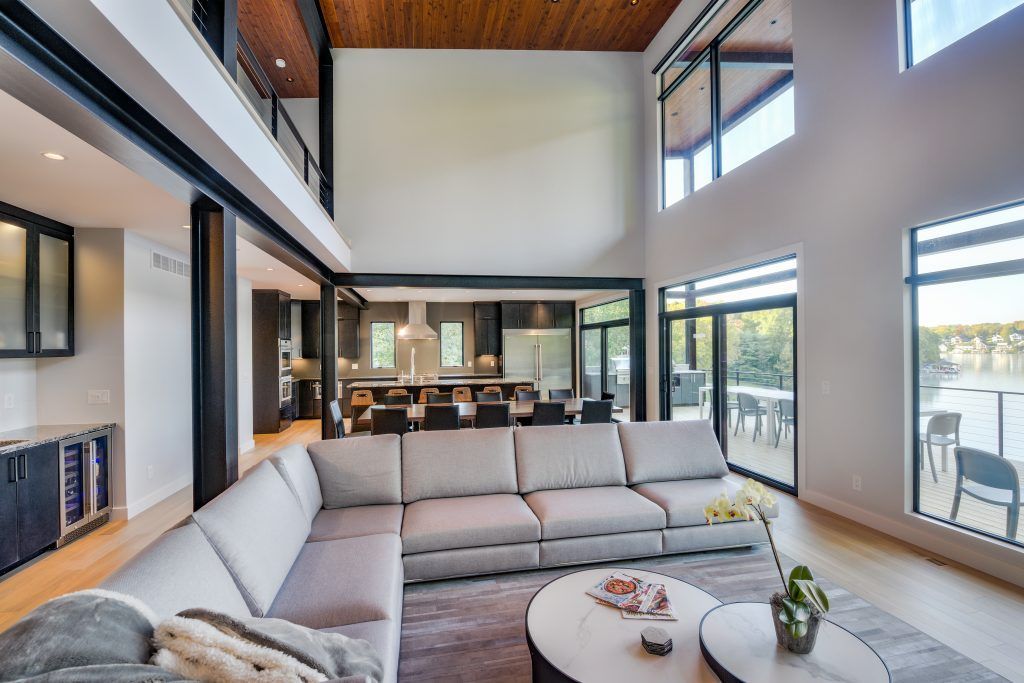 A living room with a large sectional couch and two coffee tables.