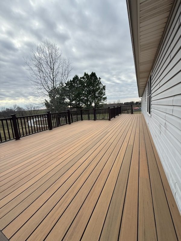 Brick building with a long wooden wheelchair ramp and handrails leading to the entrance.