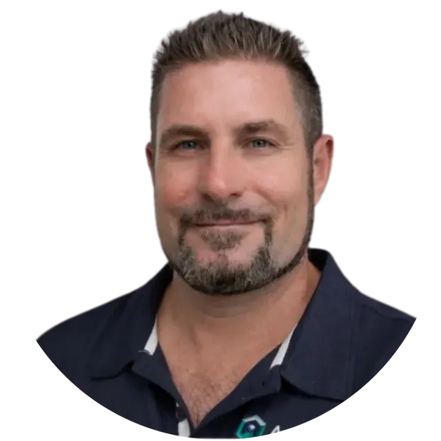 Portrait of a man with short hair and a trimmed beard, wearing a dark collared shirt on a white background