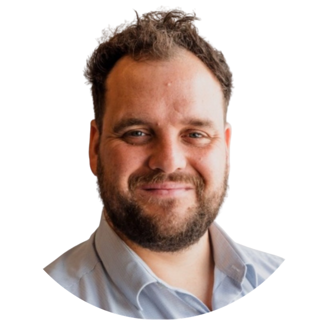Smiling bearded man in a light blue shirt on a white background